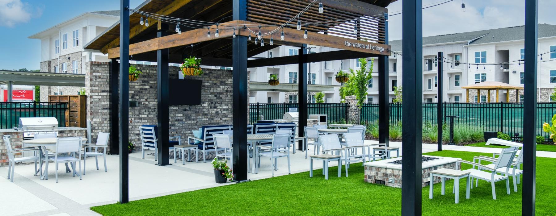 covered patio next to lawn with stringed lighting