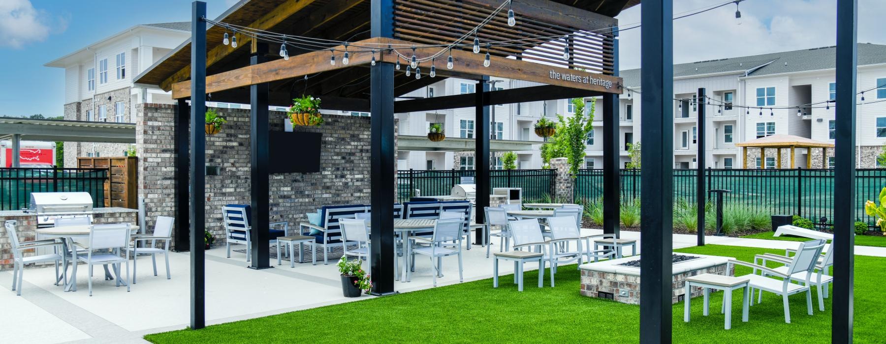 covered patio next to lawn with stringed lighting